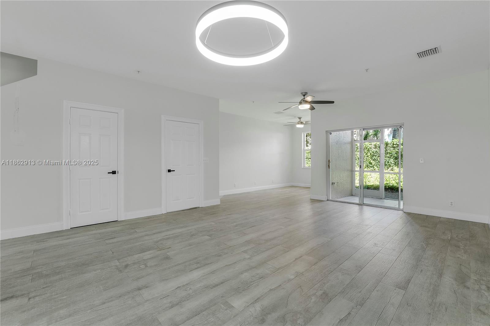 108 Lighthouse Circle, Unit E Tequesta, FL 33469 - Photo 11 of 34 wooden floor in an empty room with a window