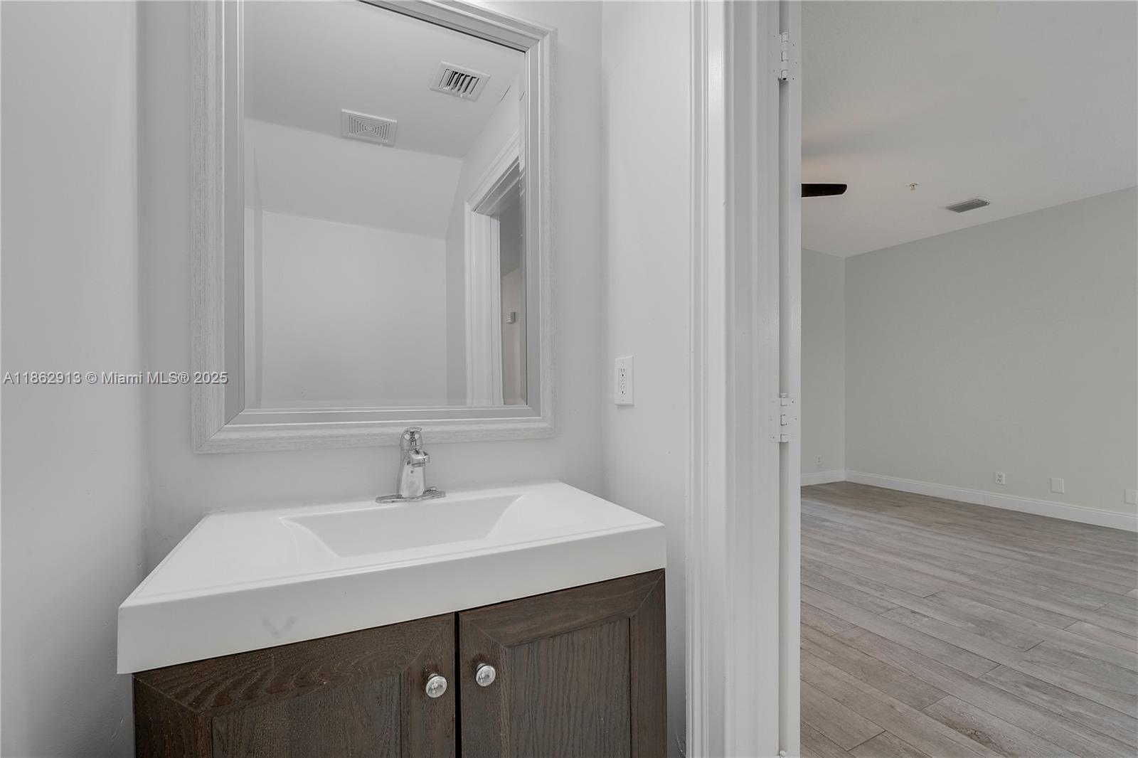 108 Lighthouse Circle, Unit E Tequesta, FL 33469 - Photo 13 of 34 a bathroom with a sink and a mirror
