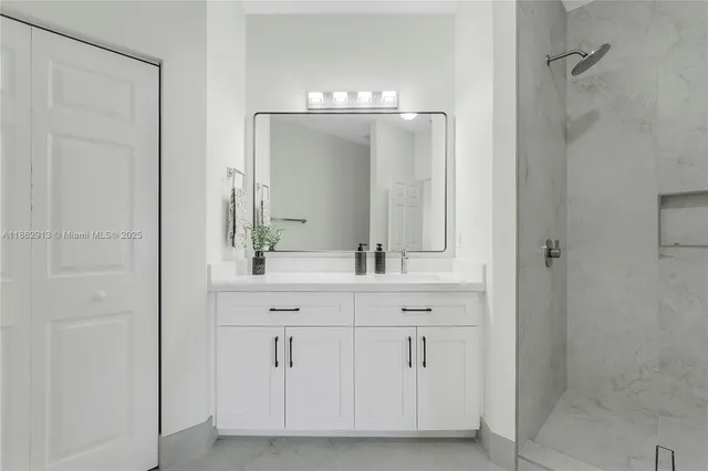 a bathroom with a double vanity sink and mirror