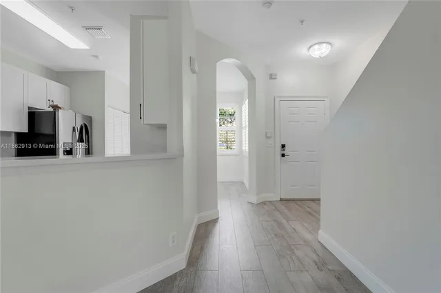 a view of a kitchen with wooden floor