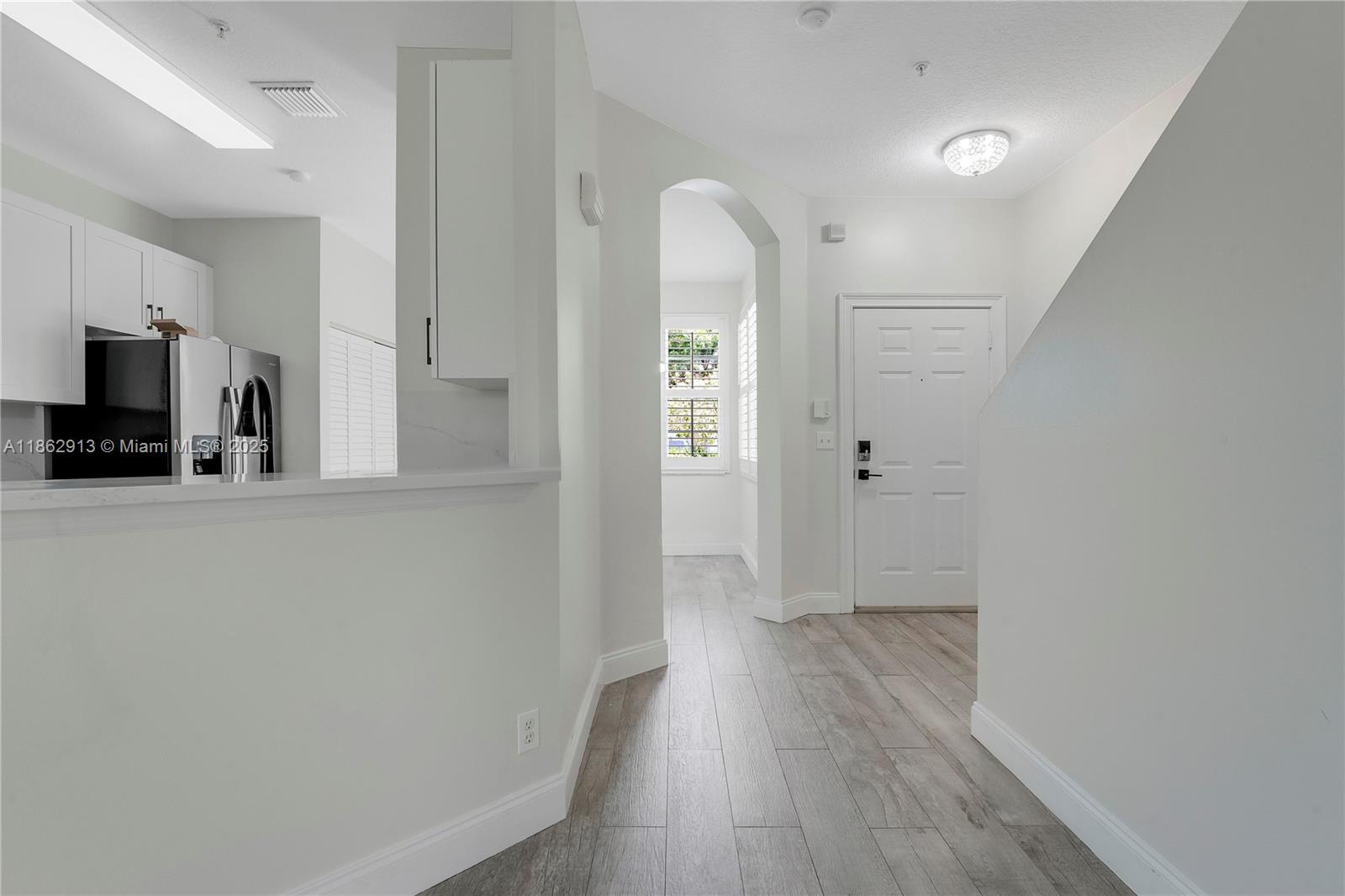108 Lighthouse Circle, Unit E Tequesta, FL 33469 - Photo 8 of 34 a view of a kitchen with wooden floor