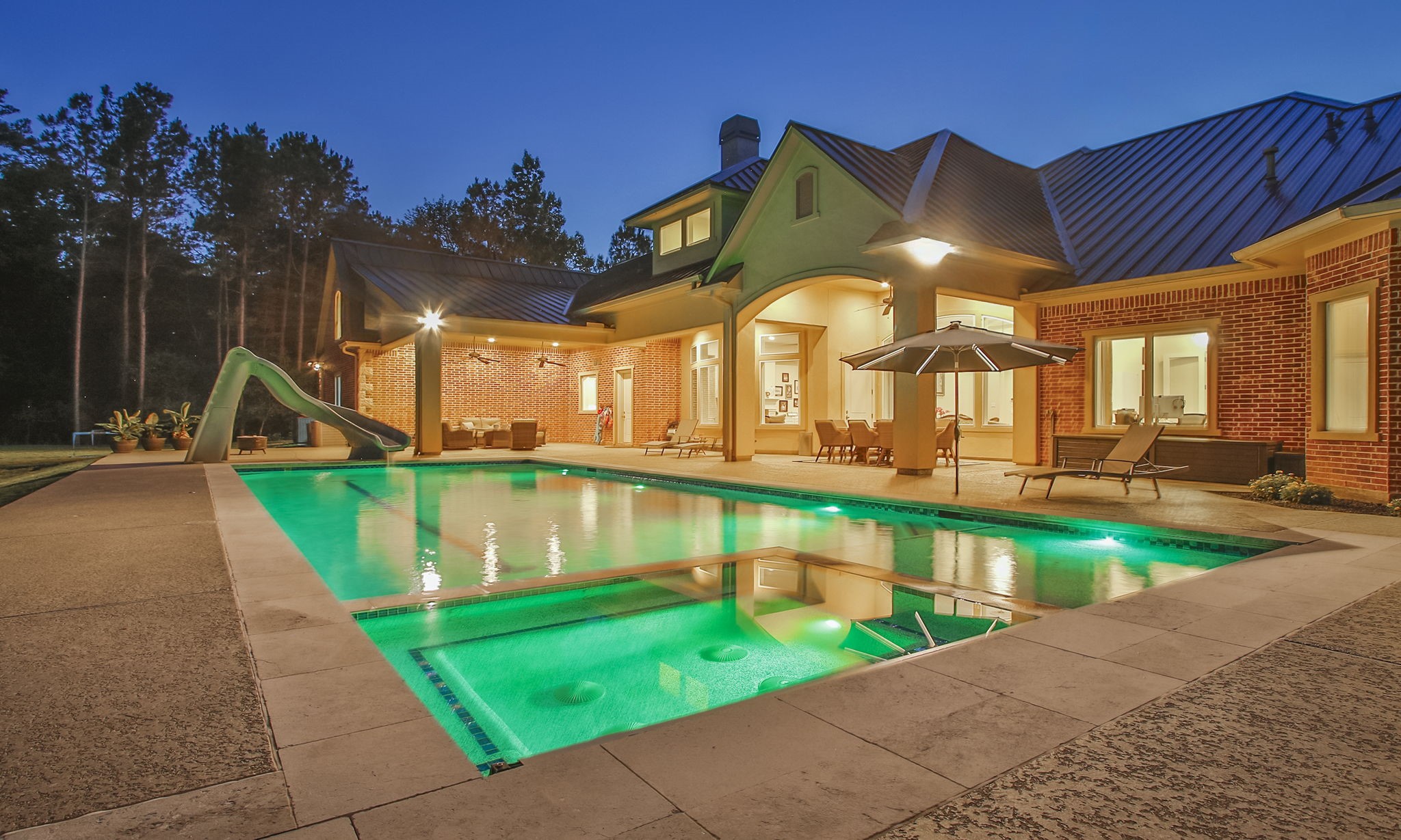 36702 Deer Valley Magnolia, TX 77355 - Photo 43 of 46 a view of a swimming pool with a bench and tables in the patio