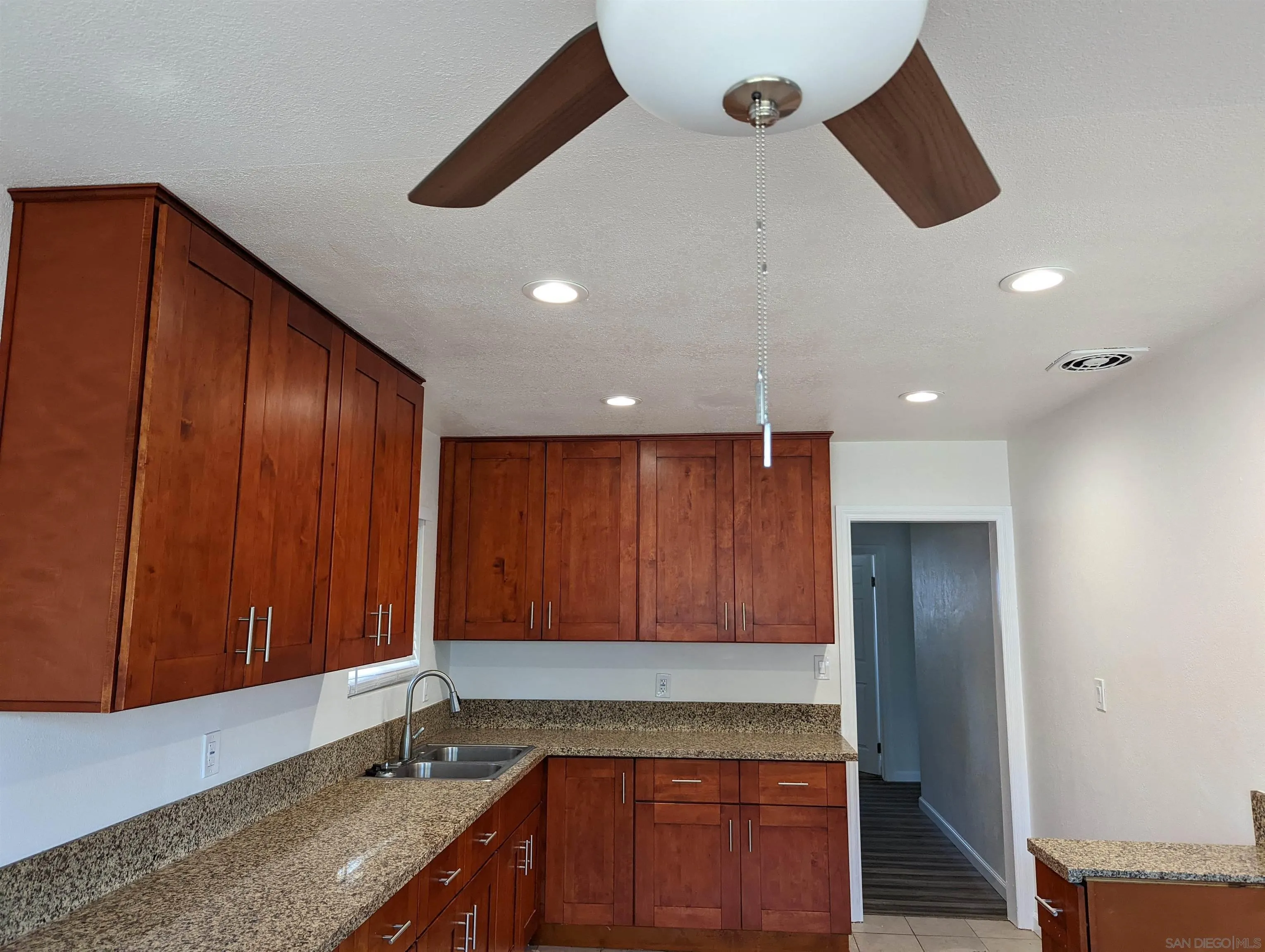 1207-9 Lyons Lane El Cajon, CA 92021 - Photo 11 of 39 a kitchen with wooden cabinets and a sink