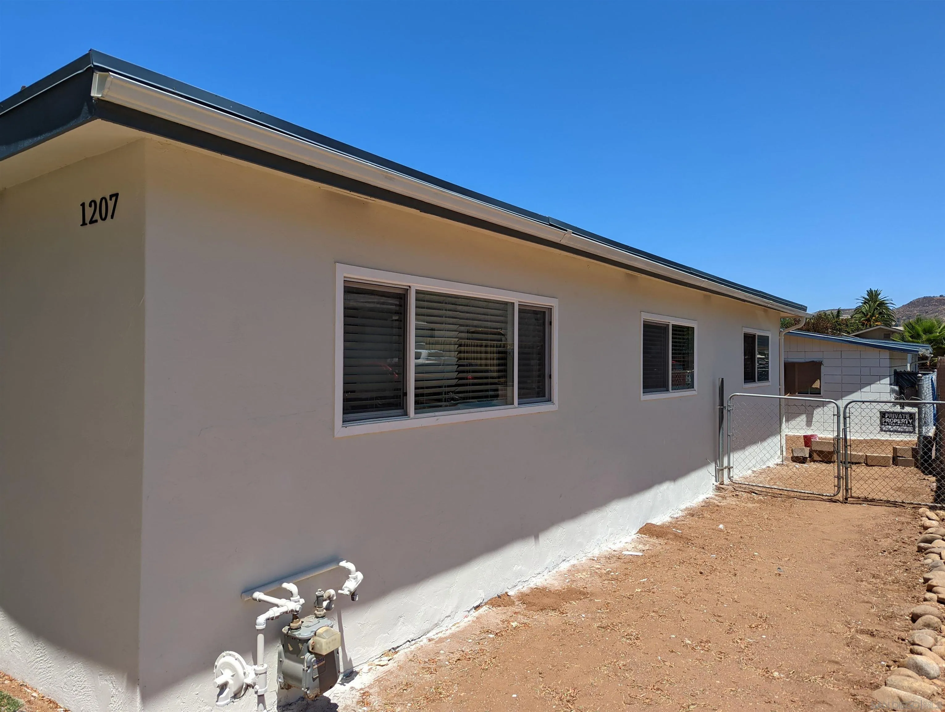 1207-9 Lyons Lane El Cajon, CA 92021 - Photo 2 of 39 a backyard of a house with table and chairs