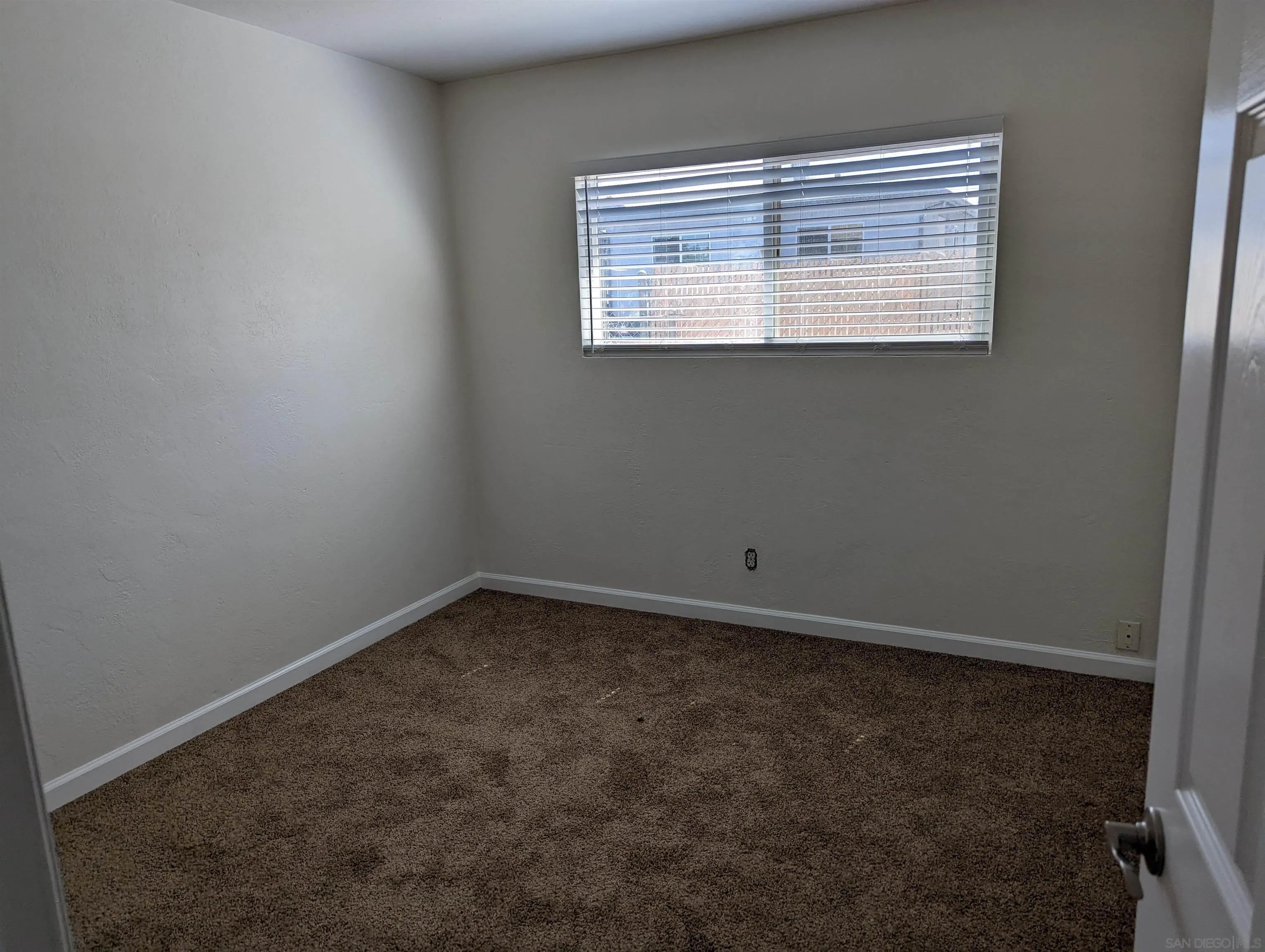 1207-9 Lyons Lane El Cajon, CA 92021 - Photo 21 of 39 an empty room with a window
