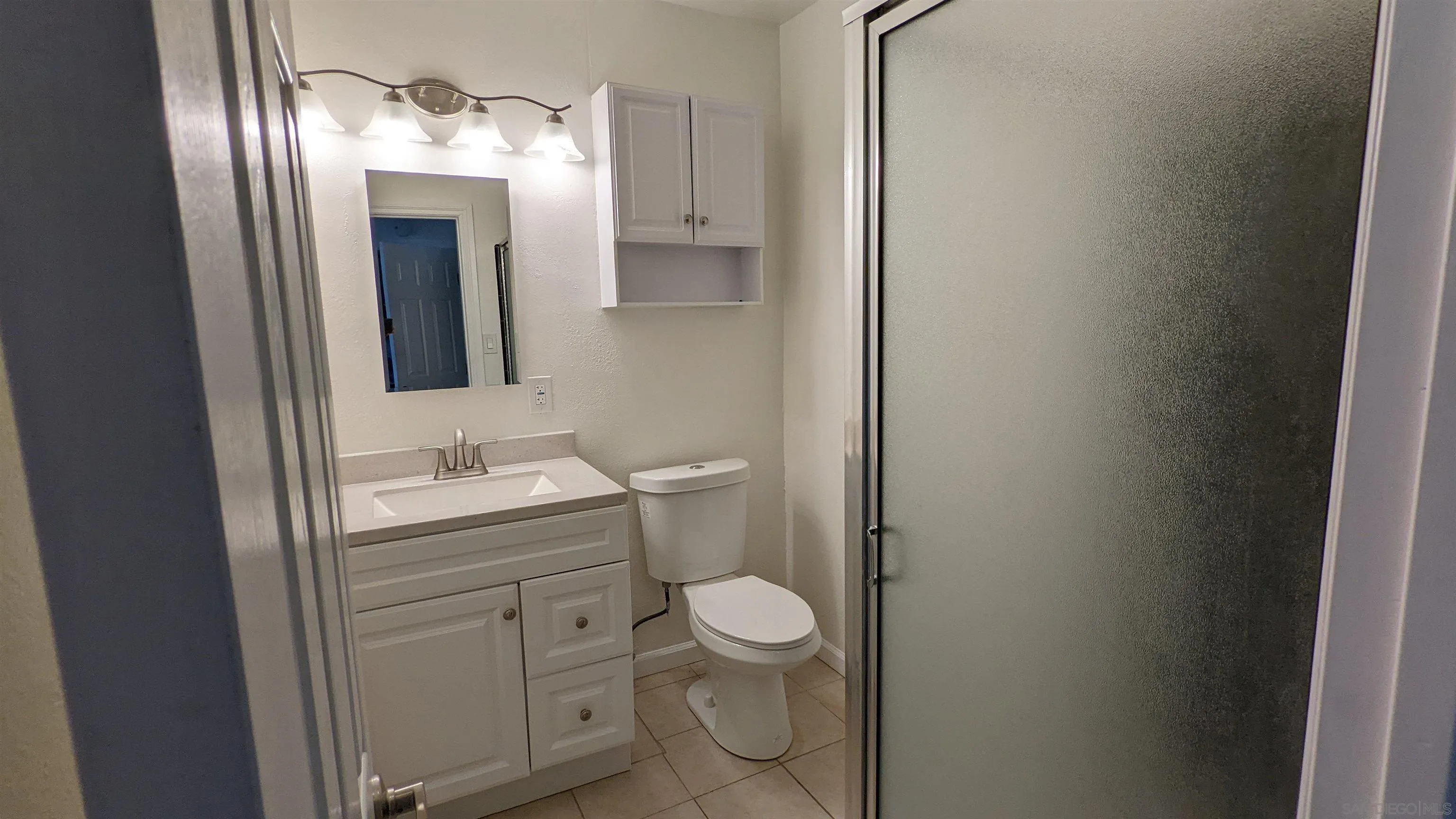 1207-9 Lyons Lane El Cajon, CA 92021 - Photo 25 of 39 a bathroom with a toilet sink and mirror