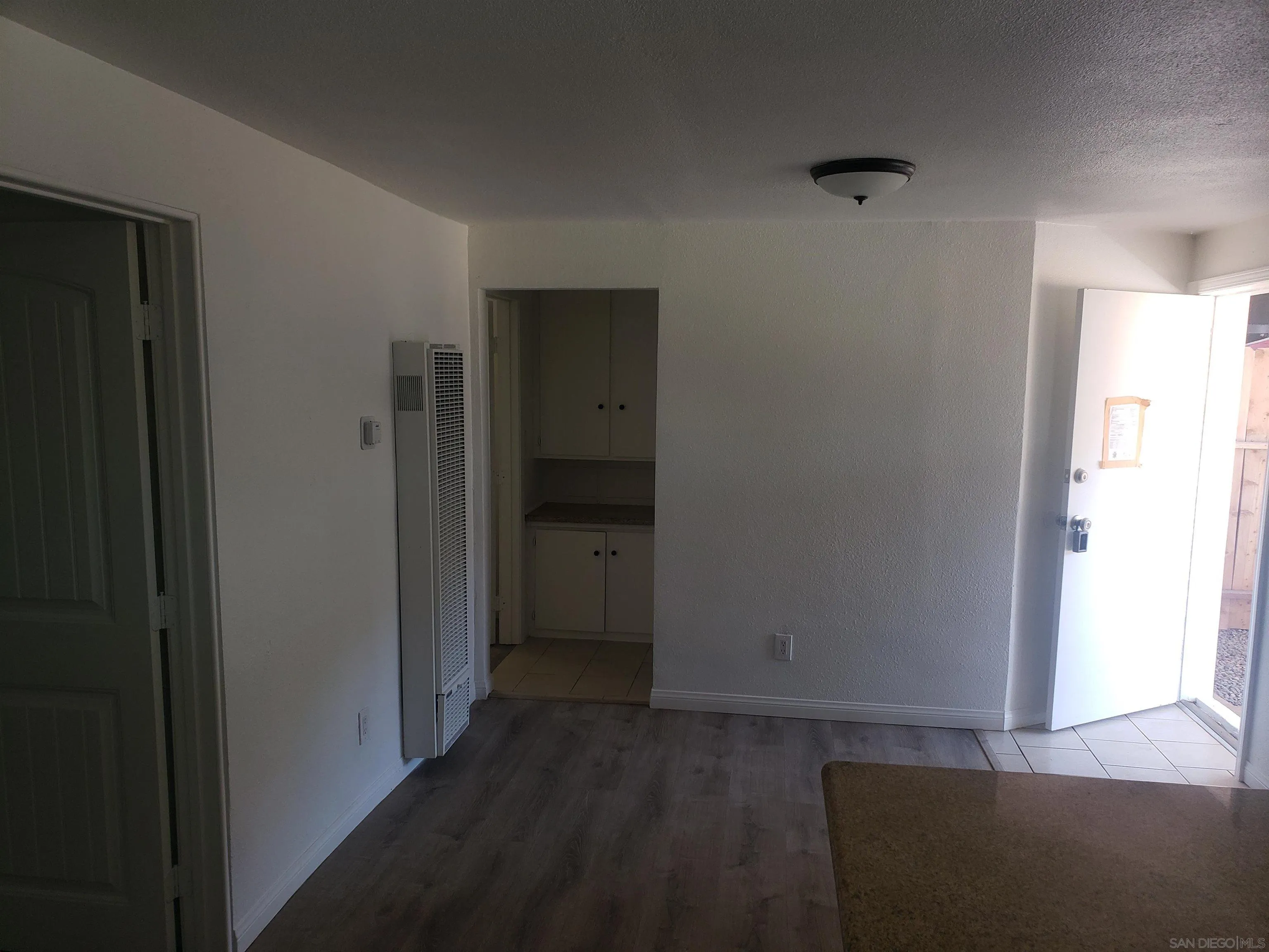 1207-9 Lyons Lane El Cajon, CA 92021 - Photo 26 of 39 a view of hallway with closet and wooden floor