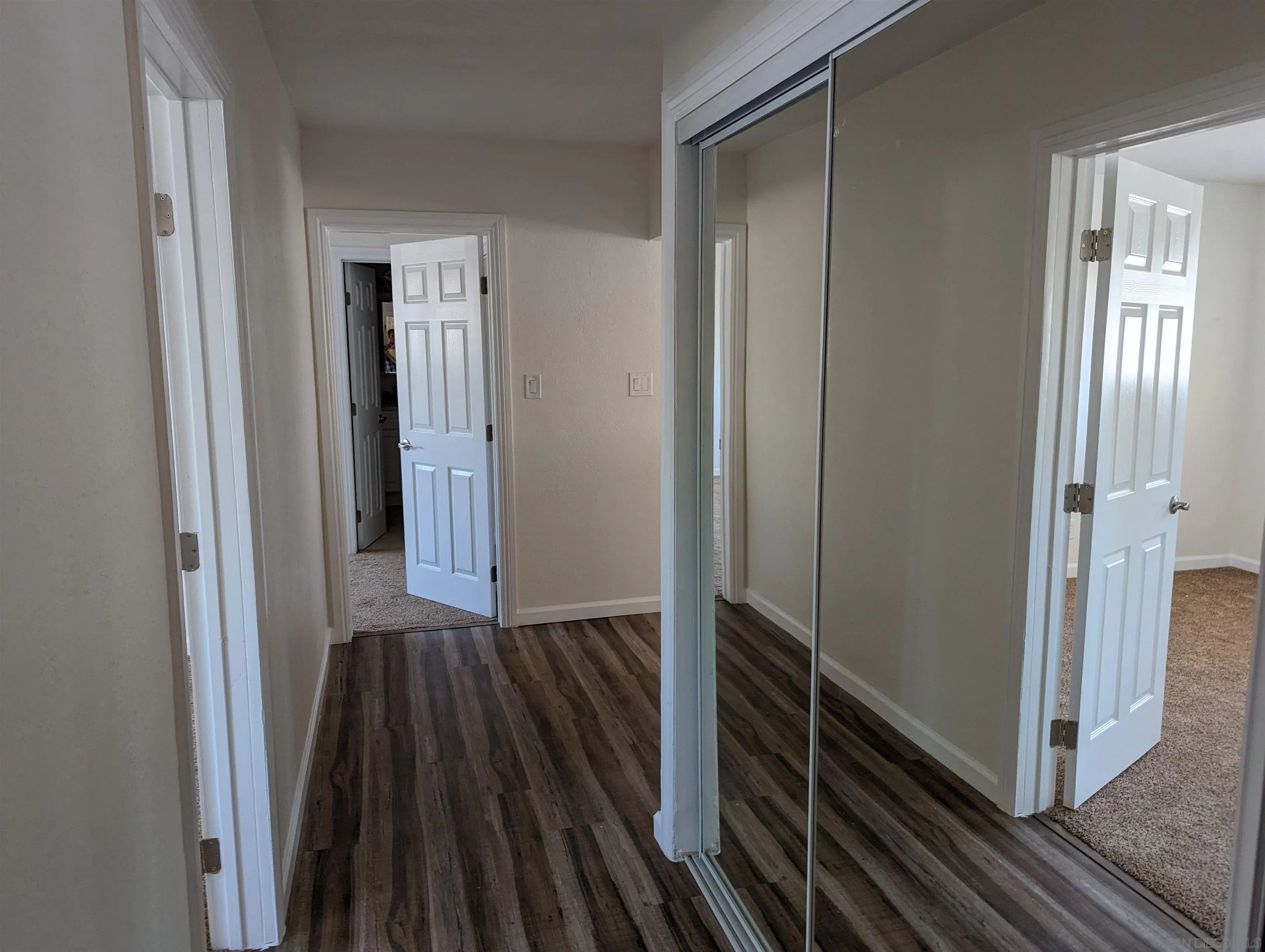 1207-9 Lyons Lane El Cajon, CA 92021 - Photo 27 of 39 a view of a hallway with wooden floor and staircase