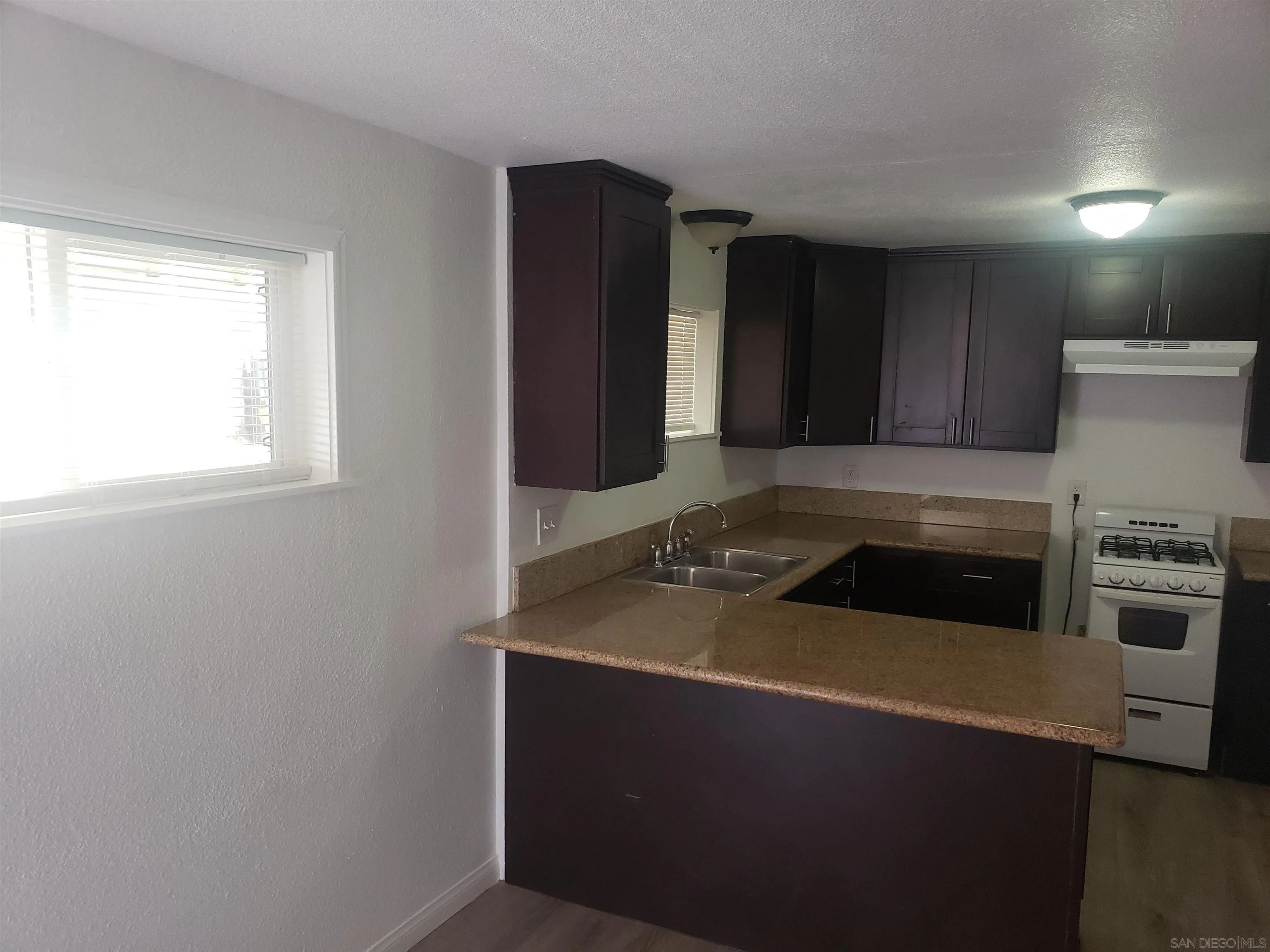 1207-9 Lyons Lane El Cajon, CA 92021 - Photo 28 of 39 a kitchen with granite countertop cabinets and steel stainless steel appliances
