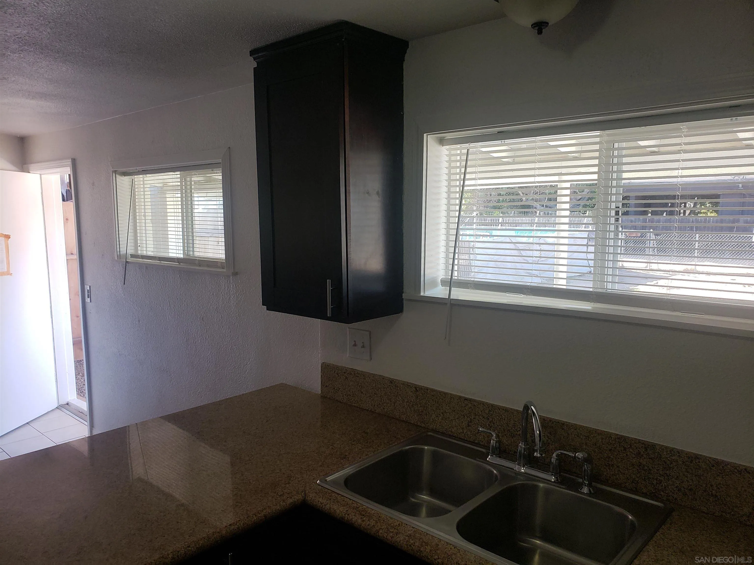 1207-9 Lyons Lane El Cajon, CA 92021 - Photo 29 of 39 a kitchen with a sink a window and cabinets