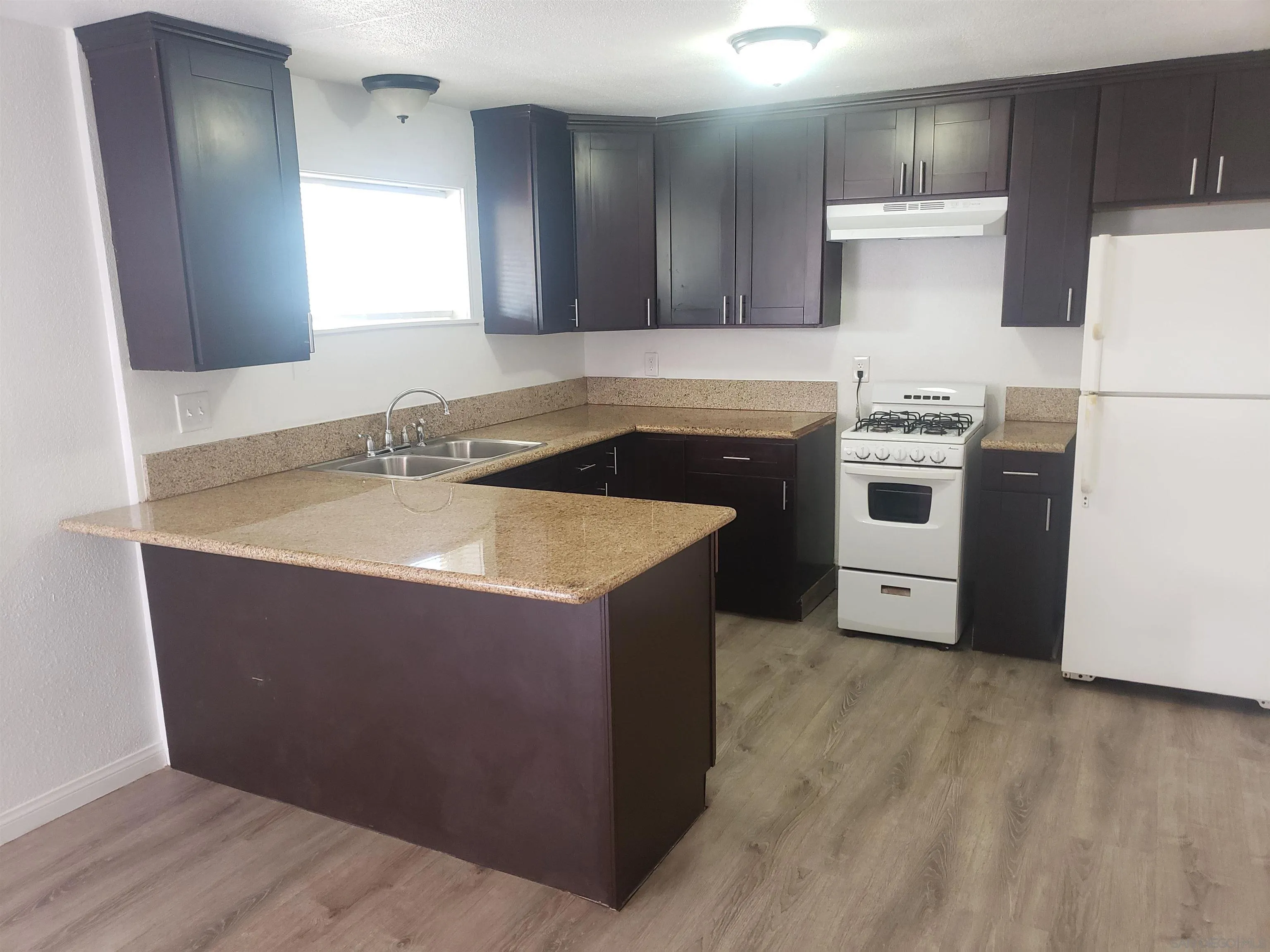 1207-9 Lyons Lane El Cajon, CA 92021 - Photo 30 of 39 a kitchen with a sink a stove a refrigerator and a microwave