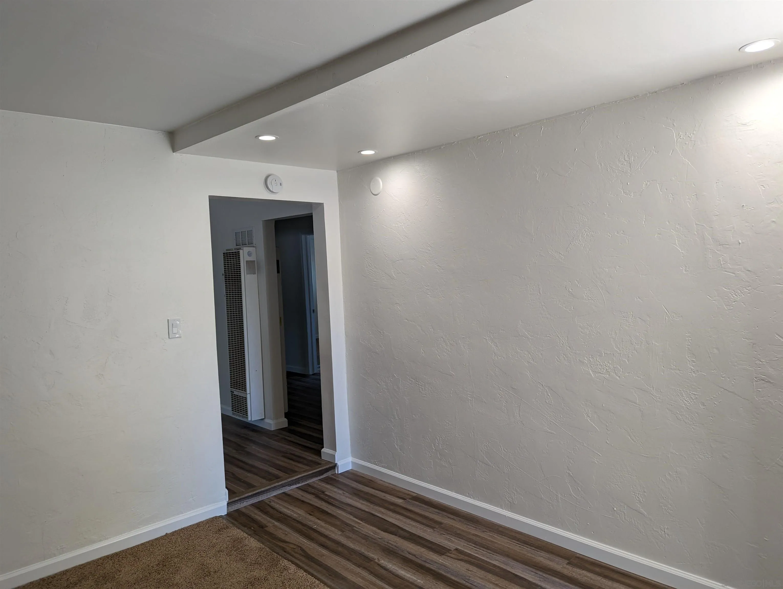 1207-9 Lyons Lane El Cajon, CA 92021 - Photo 36 of 39 a view of a livingroom with wooden floor and white wall