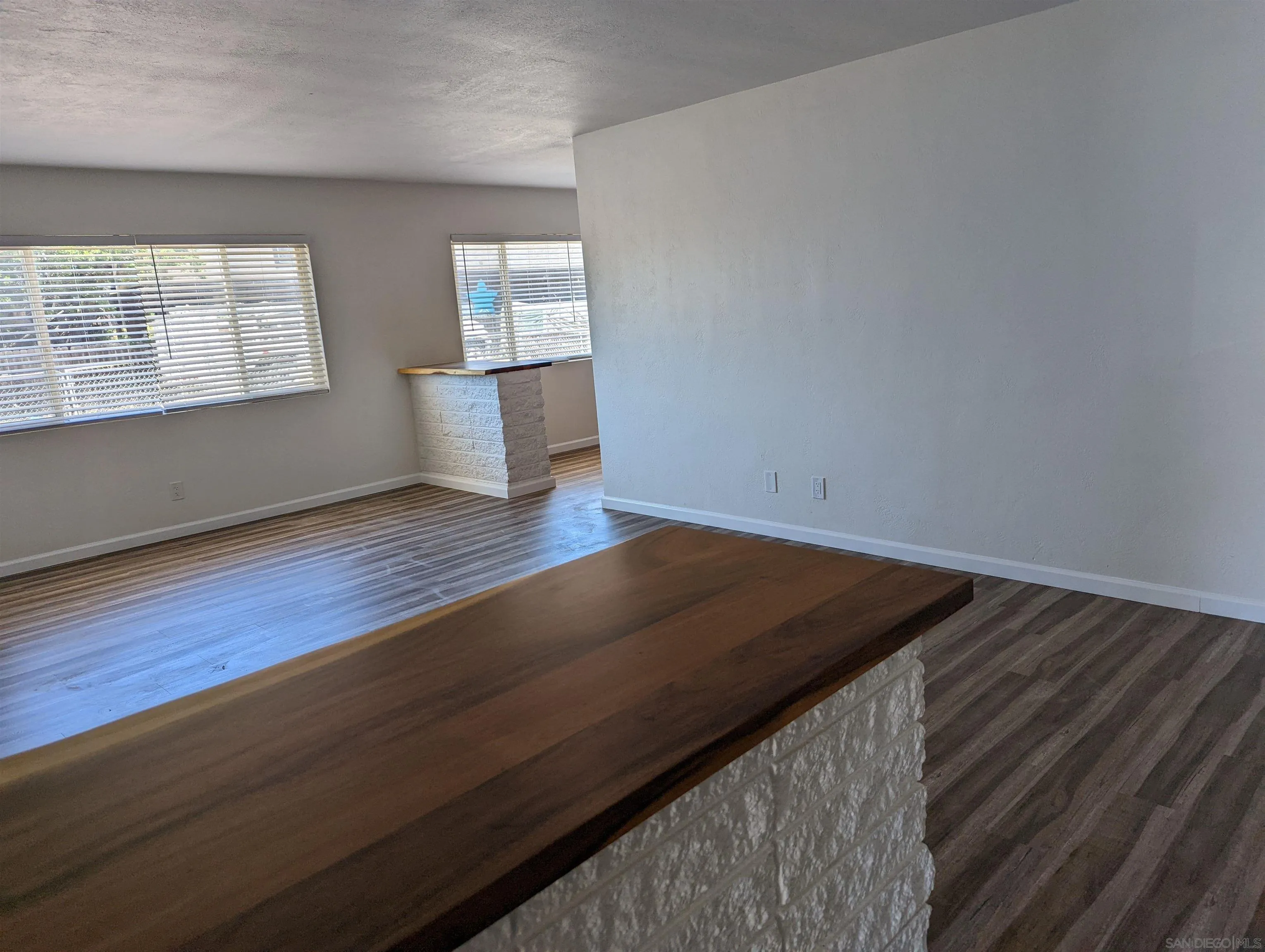 1207-9 Lyons Lane El Cajon, CA 92021 - Photo 7 of 39 an empty room with wooden floor and windows