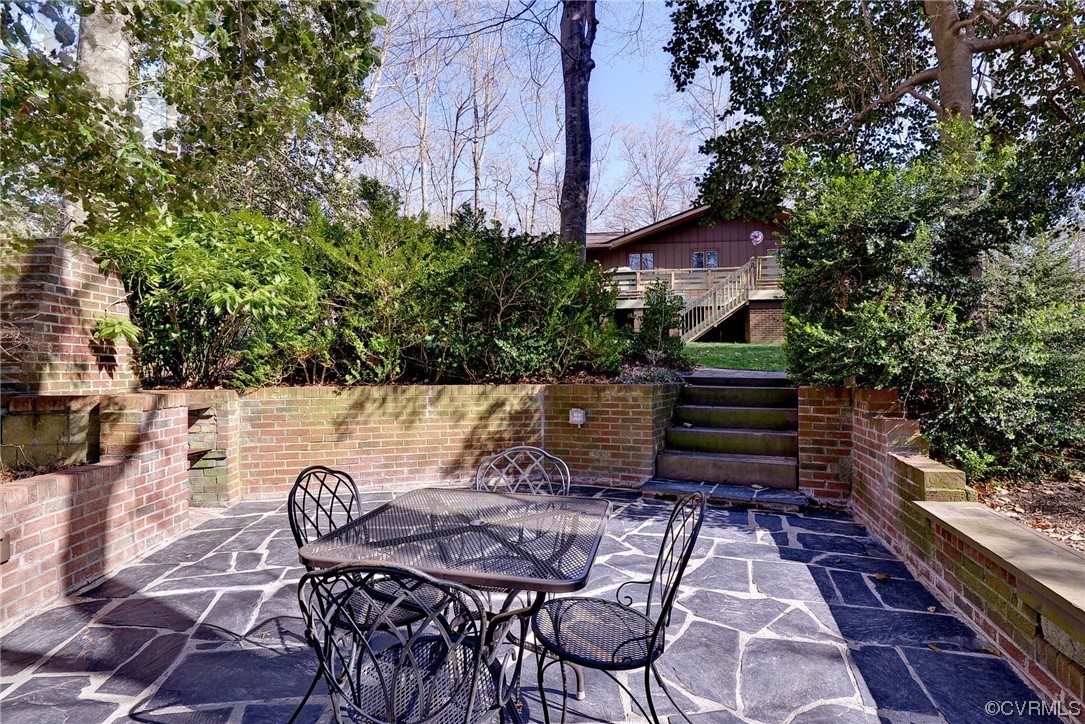121 Crownpoint Road Williamsburg, VA 23185 - Photo 8 of 10 a view of backyard with table and chairs and potted plants
