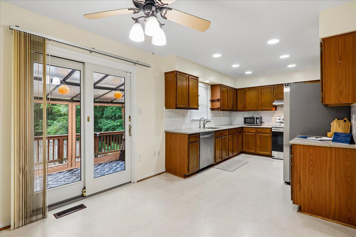 7408 Spring Tree Drive Springfield, VA 22153 - Photo 6 of 48 Sliding glass door to covered deck off of kitchen.