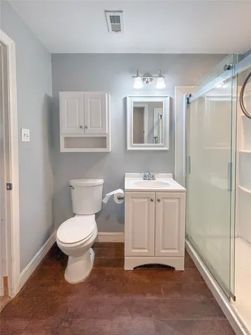 a bathroom with a sink toilet a mirror and shower