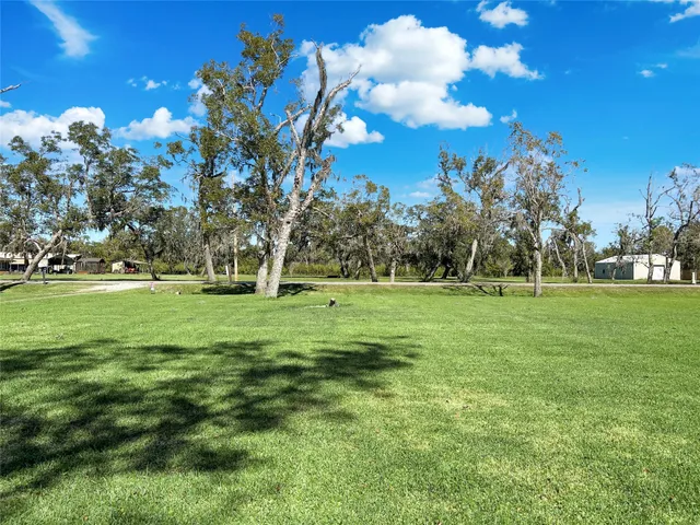 a view of grassy field with benches