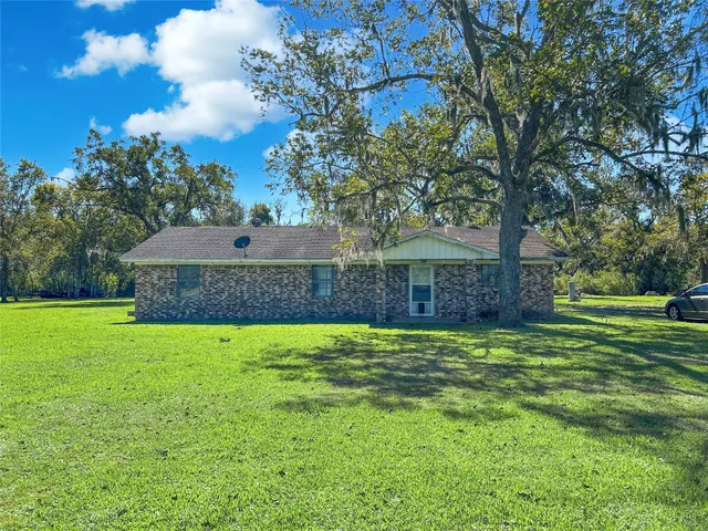 a view of a house next to a big yard