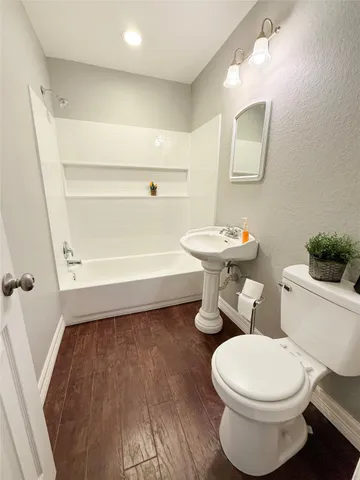 a bathroom with a toilet a sink and a mirror