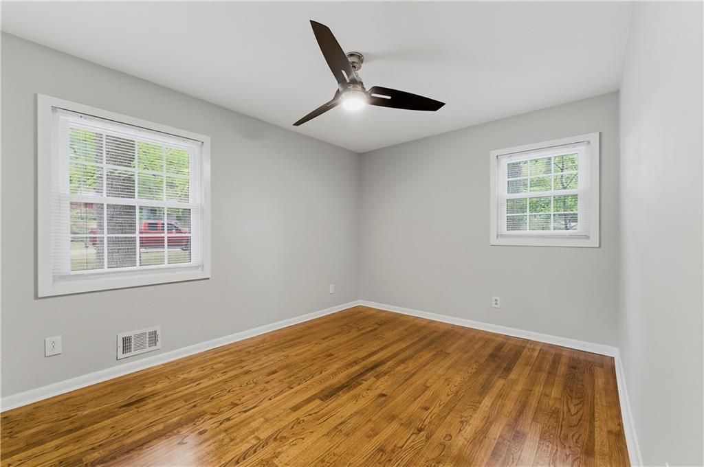 1063 Seville Drive Clarkston, GA 30021 - Photo 14 of 25 a view of an empty room with wooden floor and a window