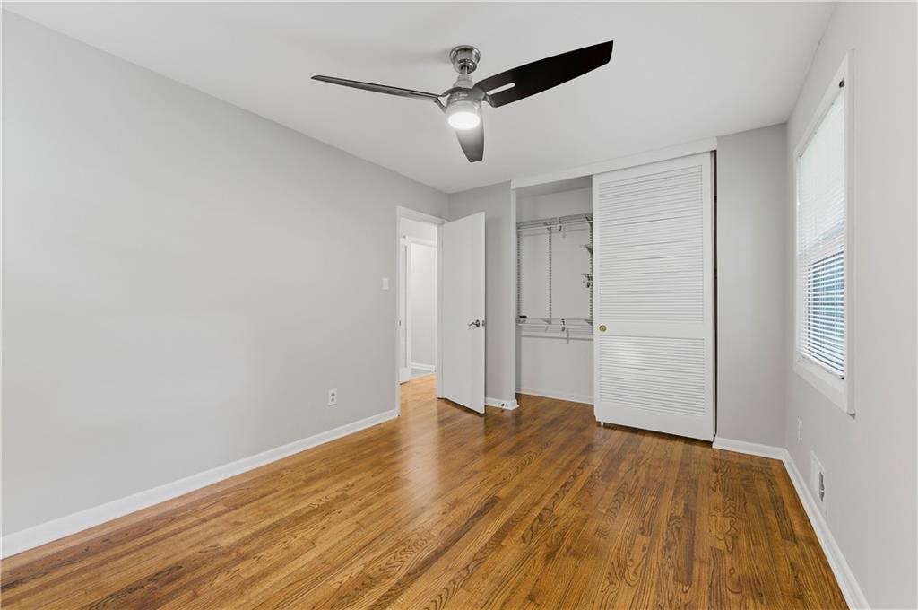 1063 Seville Drive Clarkston, GA 30021 - Photo 15 of 25 a view of an empty room with wooden floor