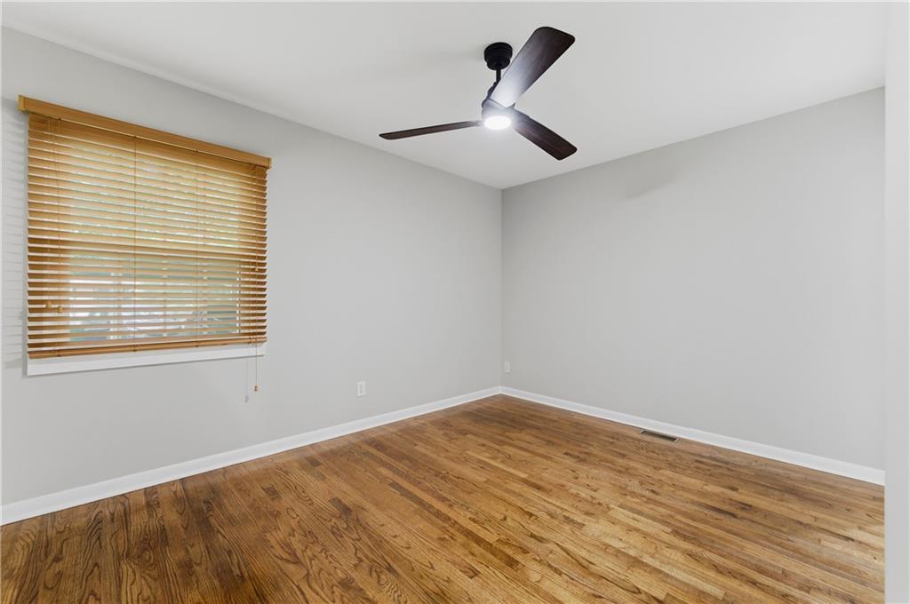 1063 Seville Drive Clarkston, GA 30021 - Photo 16 of 25 a view of a big room with wooden floor and a window