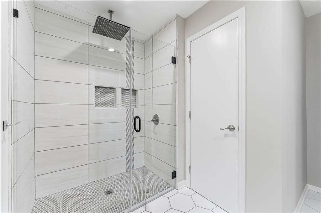 1063 Seville Drive Clarkston, GA 30021 - Photo 19 of 25 a bathroom with a shower