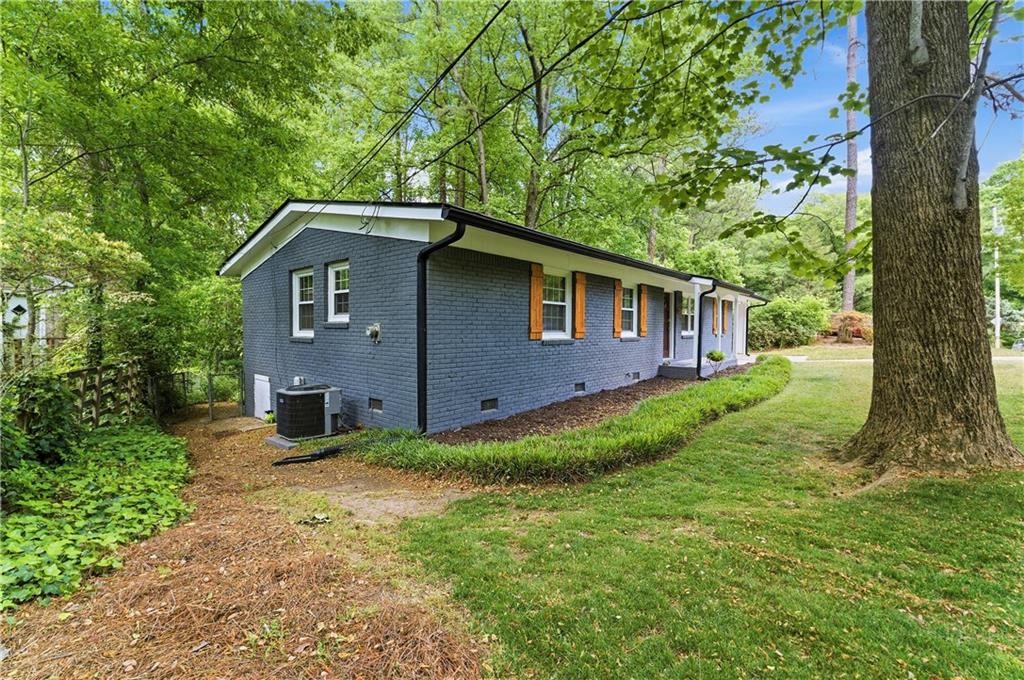 1063 Seville Drive Clarkston, GA 30021 - Photo 2 of 25 a front view of a house with garden
