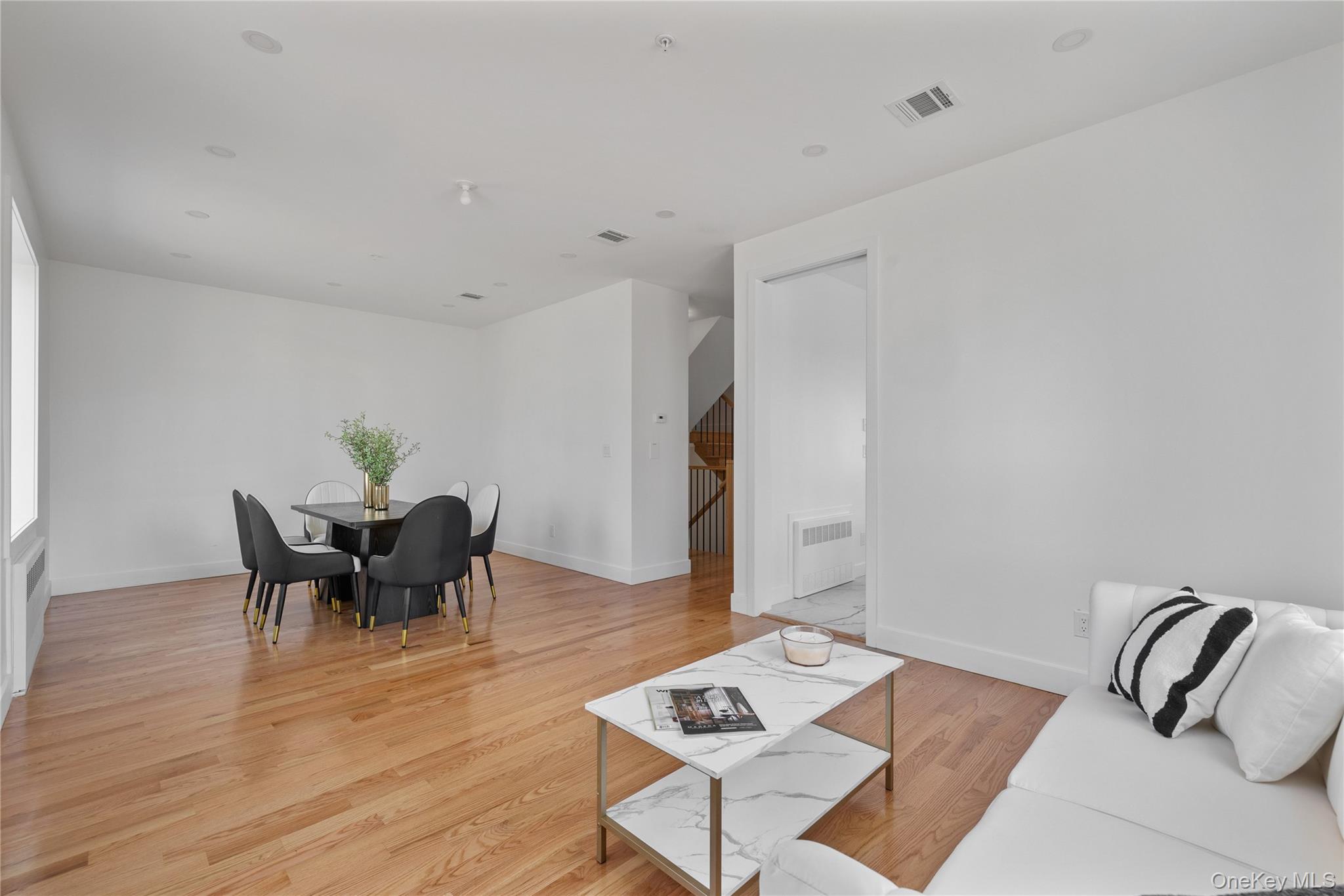 236 Old Nyack Turnpike, Unit 202 Spring Valley, NY 10977 - Photo 17 of 49 a living room with furniture and wooden floor