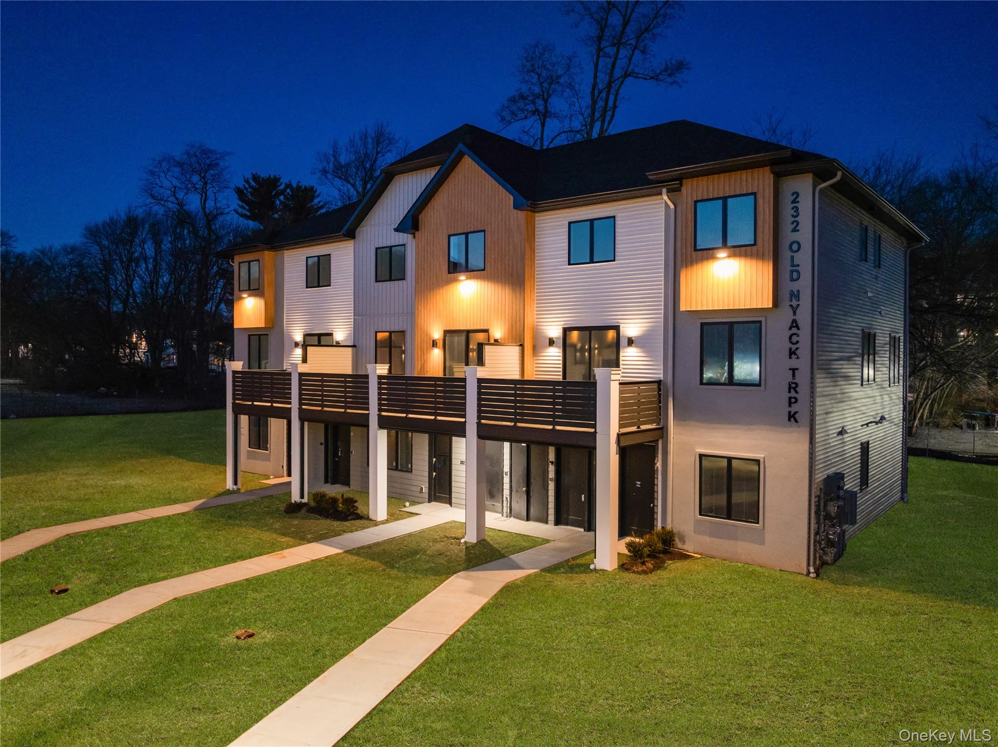 236 Old Nyack Turnpike, Unit 202 Spring Valley, NY 10977 - Photo 2 of 49 a front view of a house with a yard