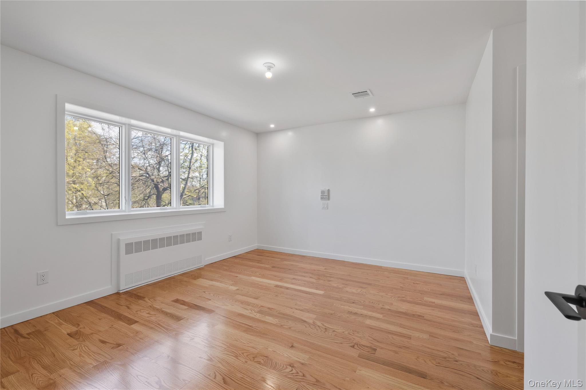 236 Old Nyack Turnpike, Unit 202 Spring Valley, NY 10977 - Photo 24 of 49 a view of empty room with wooden floor and fan