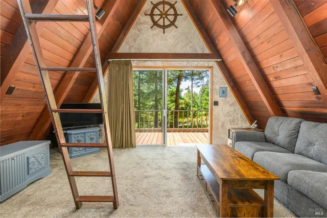 a living room with furniture and a floor to ceiling window