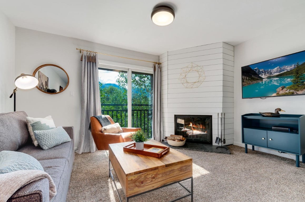 401 South Ridge Street, Unit 21 Breckenridge, CO 80424 - Photo 1 of 12 a living room with furniture and a fireplace