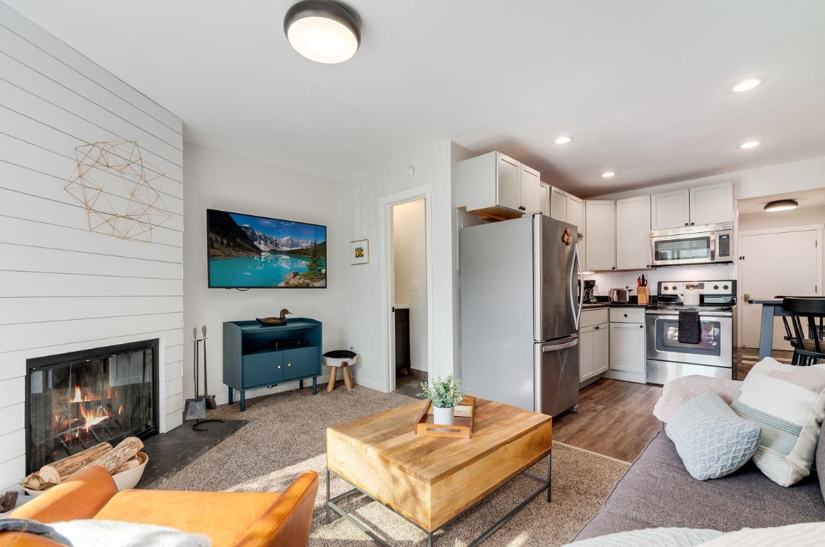 401 South Ridge Street, Unit 21 Breckenridge, CO 80424 - Photo 3 of 12 a living room with furniture and a fireplace