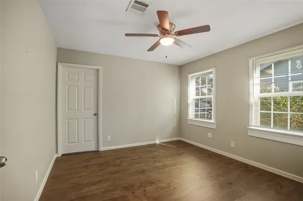 a view of a backyard with table and chairs and garden