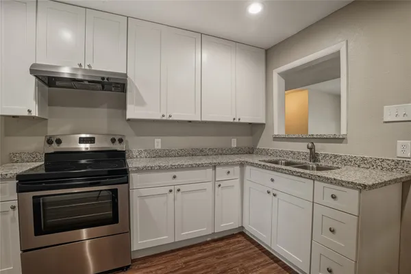 a view of an empty room with window and a fan