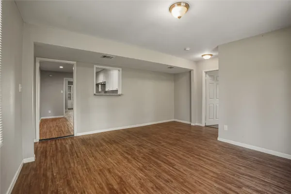 a bathroom with a granite countertop sink a toilet and a mirror
