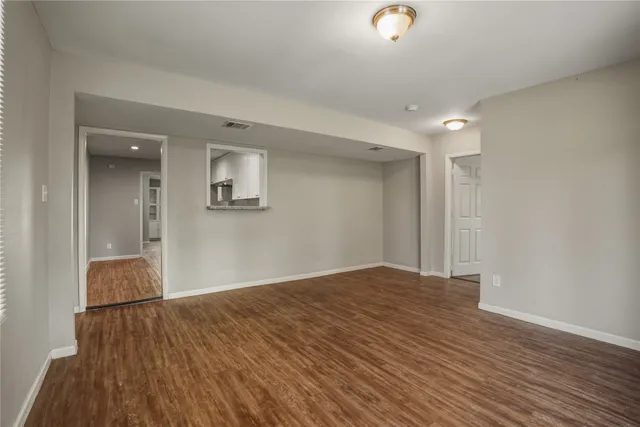 a bathroom with a granite countertop sink a toilet and a mirror