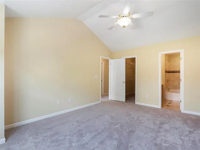 a bathroom with a granite countertop sink a mirror a bathtub and shower