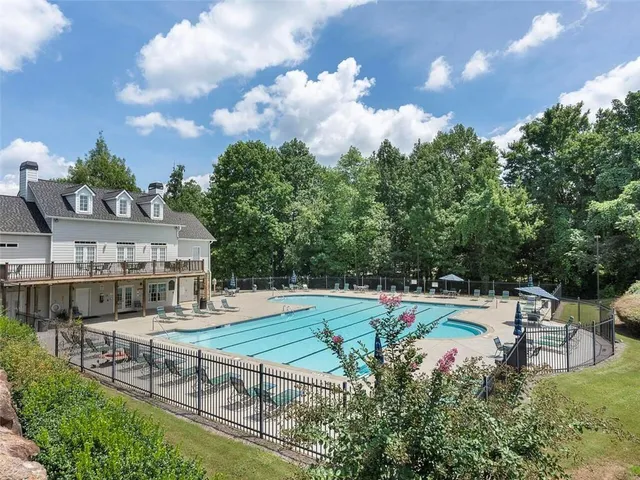 a view of a chairs and table in patio with a yard