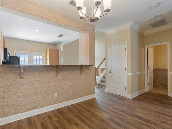 a view of a livingroom with wooden floor and stairs