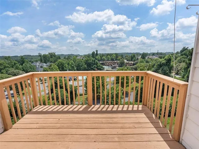 a balcony with wooden floor in city view