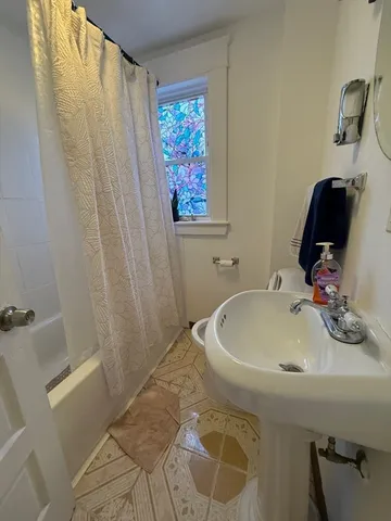 a bathroom with a sink and a shower curtain