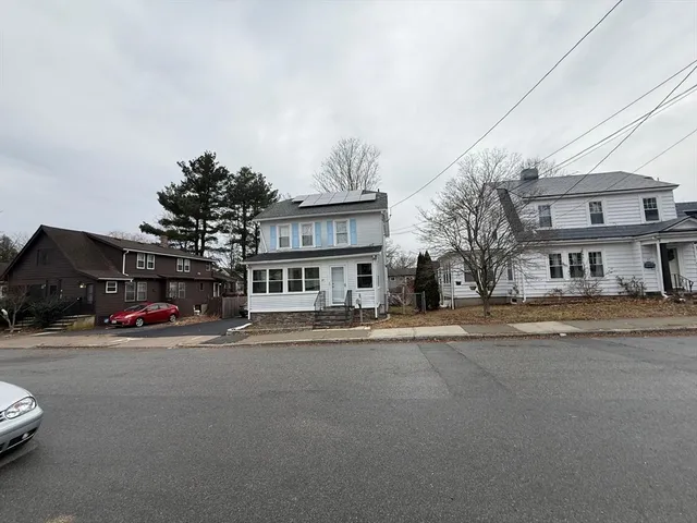a view of a street with a car parked in front of it