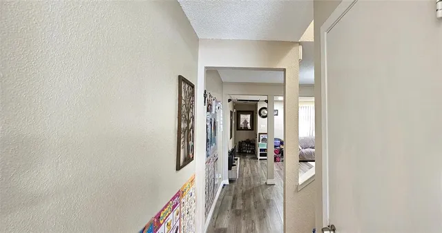 a view of a hallway with a livingroom and a hallway