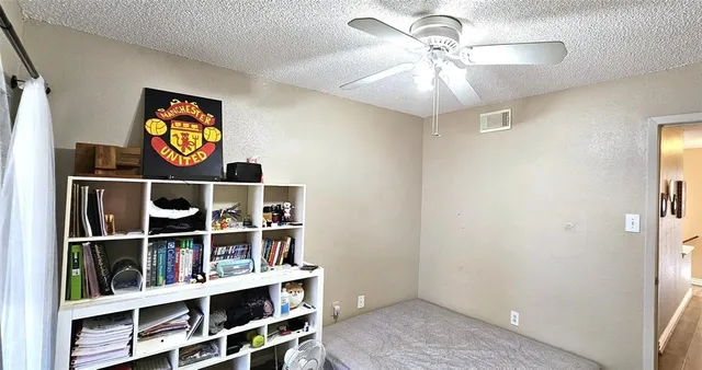 a view of a book shelf with wooden floor