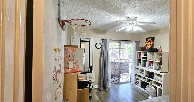 a view of a hallway with wooden floor and workspace