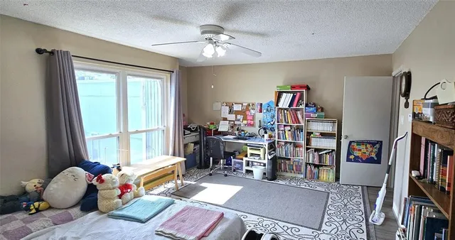 a living room with lots of furniture and a book shelf