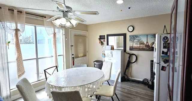 a view of a dining room with furniture a chandelier and wooden floor