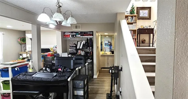 a view of a dining room with furniture and chandelier